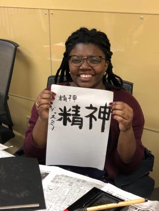 Student showing off her calligraphy work.