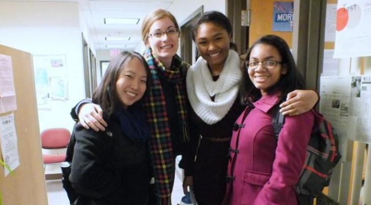 Four students hugging each other.