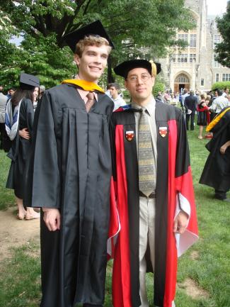 Abram Wagner at graduation with a professor.