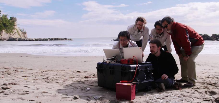 Nathaniel Guy on a beach with peers.