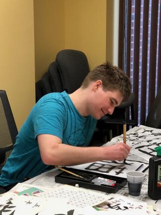 Student doing calligraphy.