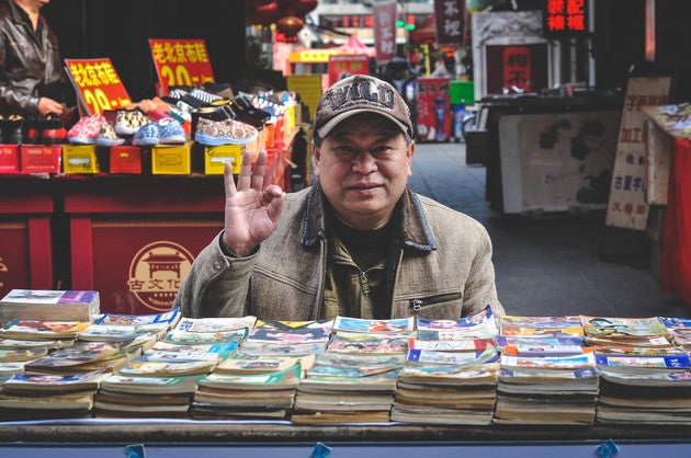 Man selling paper in China.
